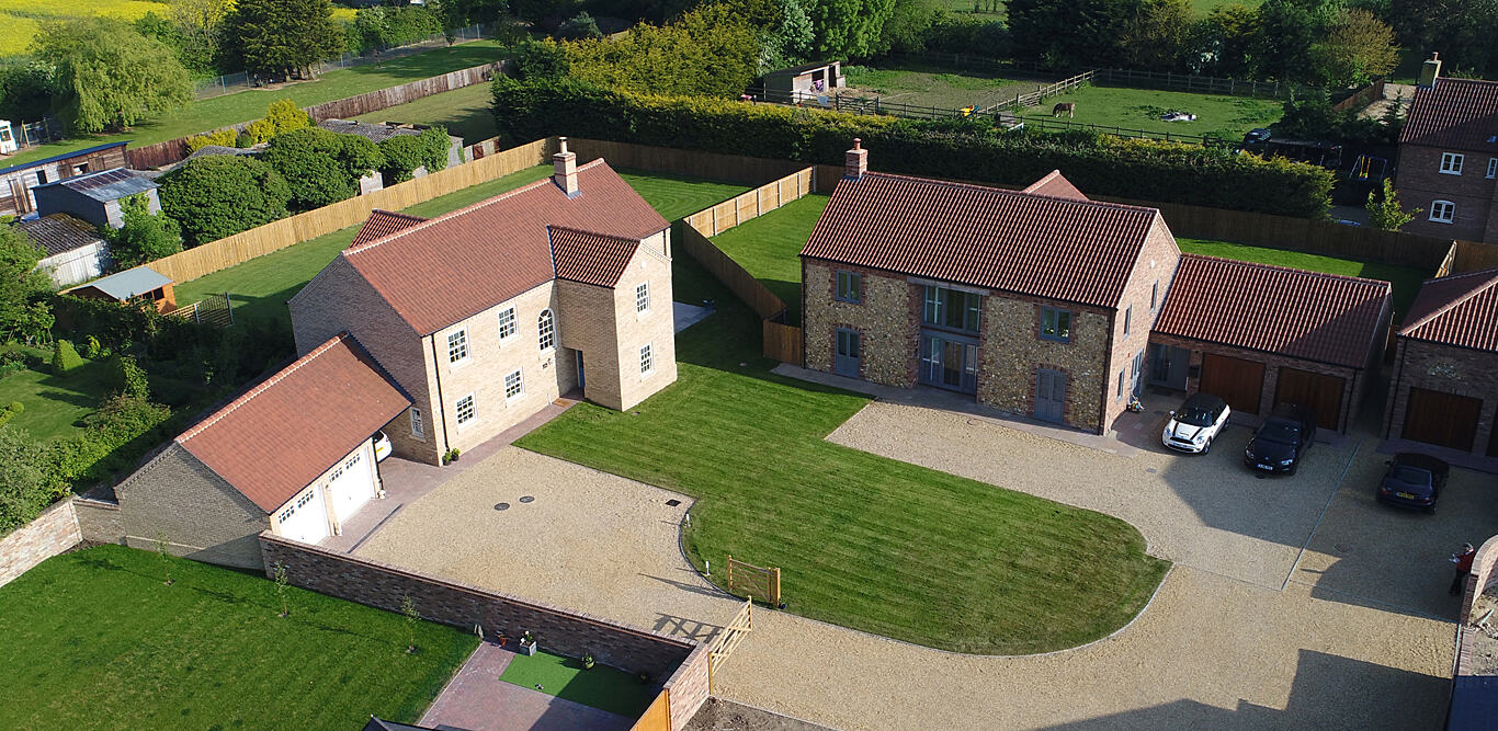 Aerial view of new homes around a gravel drive