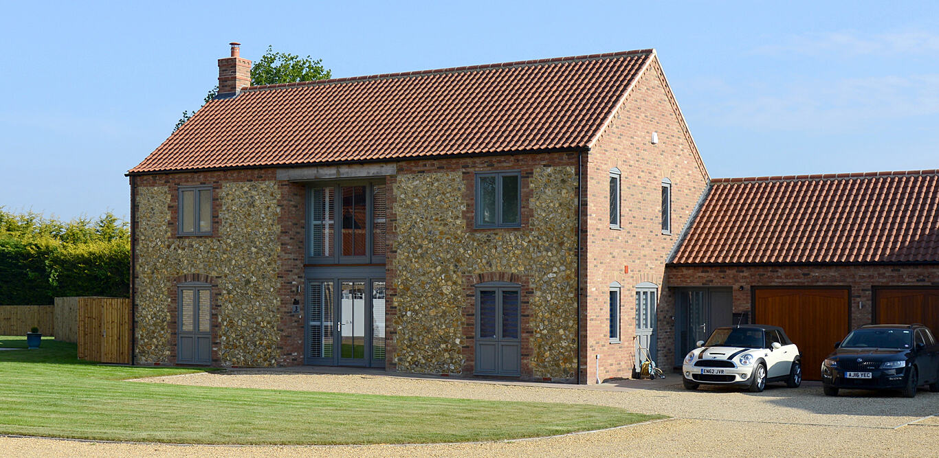 Flint and brick detached home with double garage, built by Derek Hales Limited