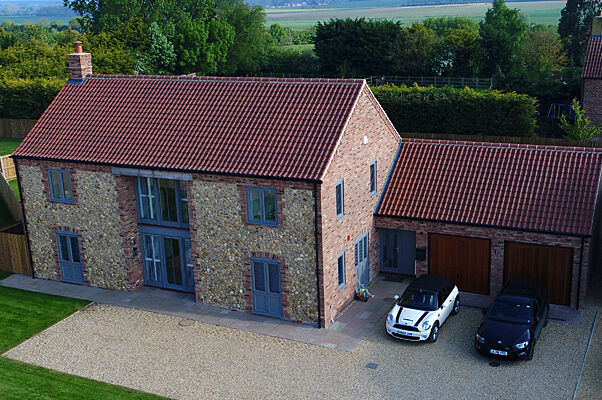 Aerial view of a flint and brick new home