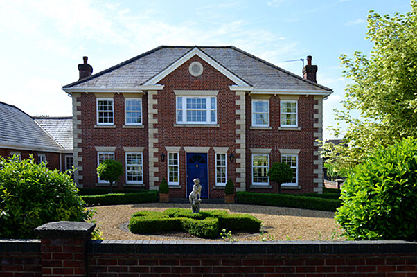 Symmetrical red brick house built by Derek Hales Limited