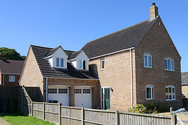 Brick house with dormer windows and double garage