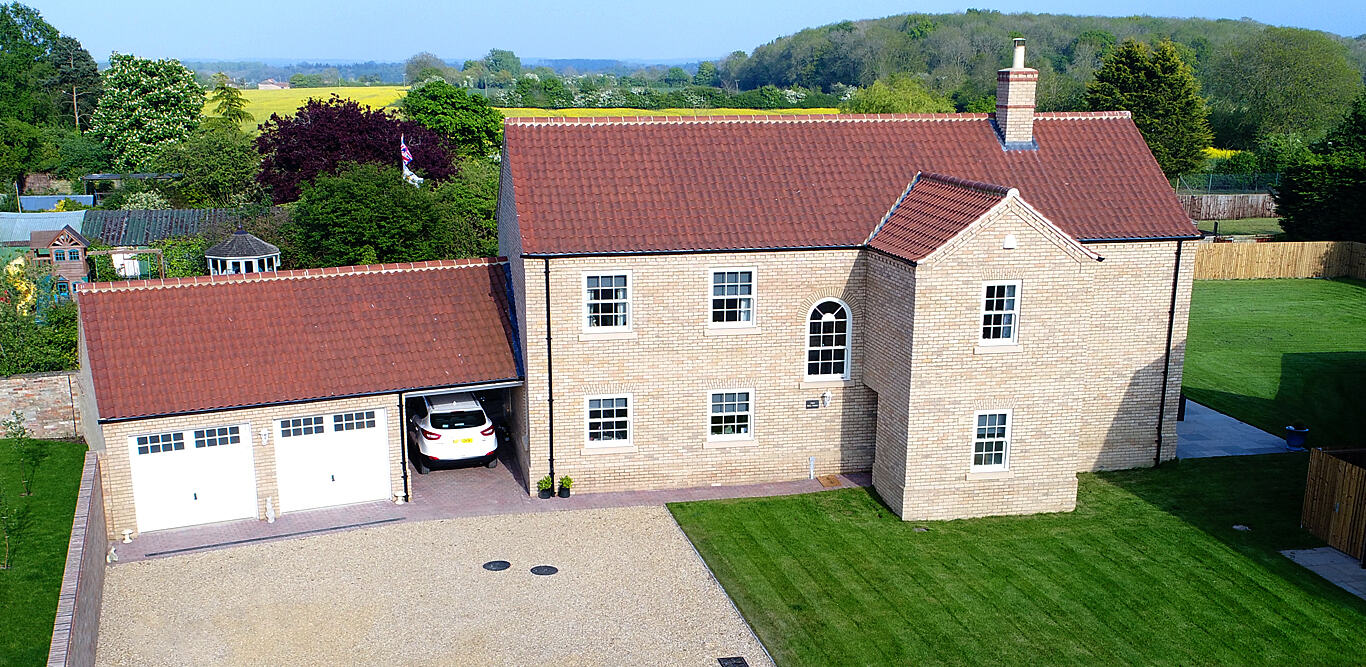 Aerial view of a carrstone house with double garage